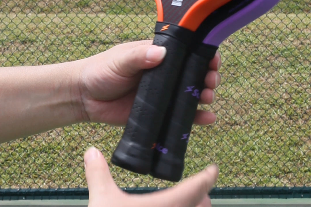 a girl holding a pickleball paddle on the pickleball court